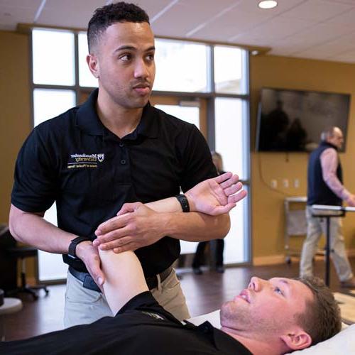 A student rehearses an adjustment within the DPT program
